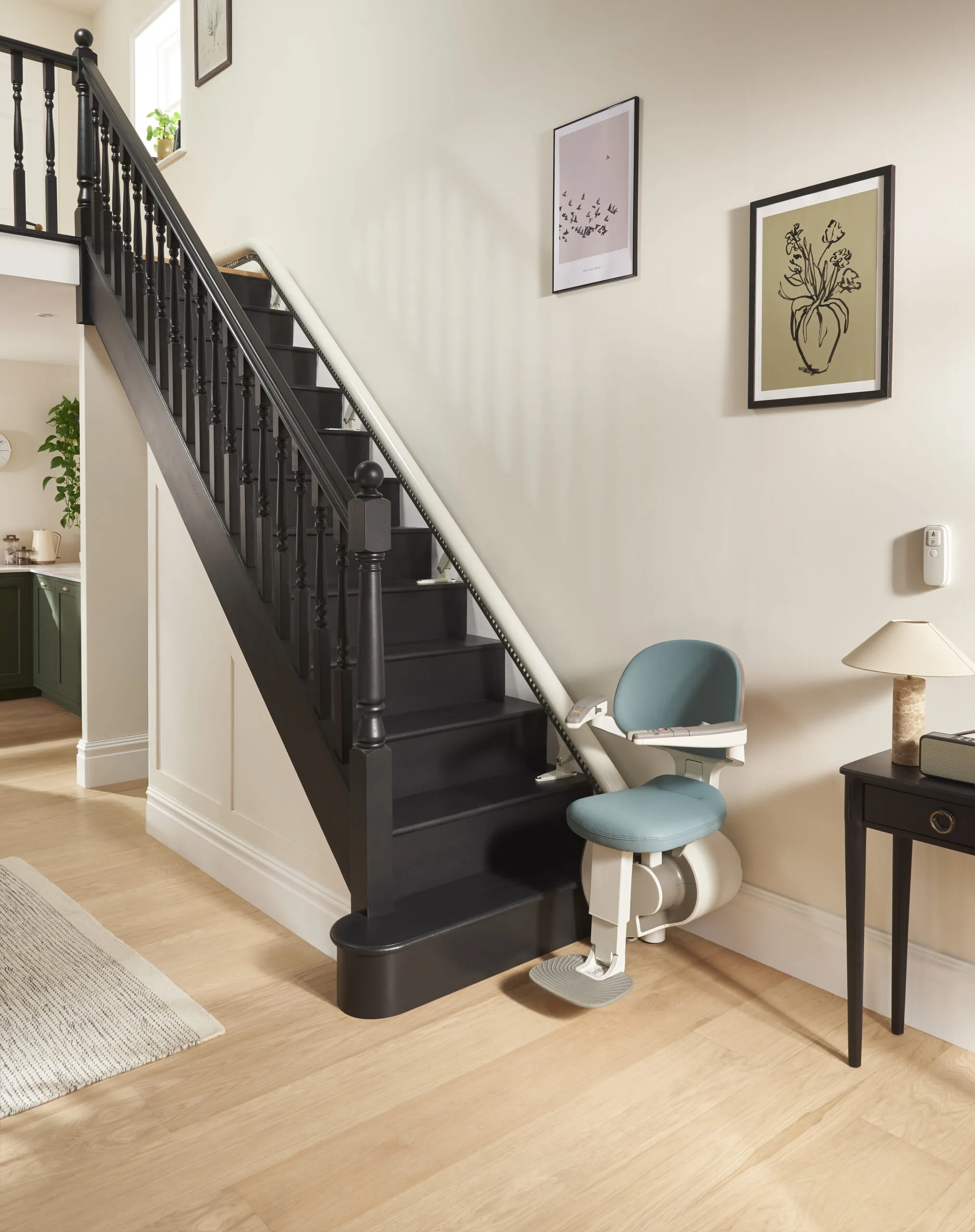 Straight stairlift fitted on black stairs inside a Cardiff home